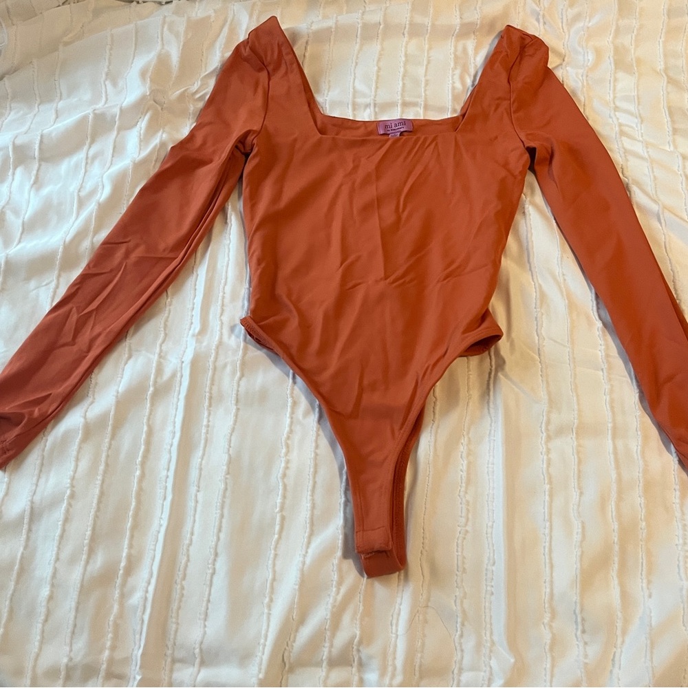 Francesca’s like new orange bodysuit